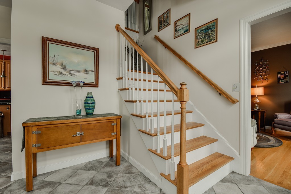 22 Hardwick Road Ashland, MA 01721 - Photo 3 of 24 a view of staircase with lots of frames on wall and stairs