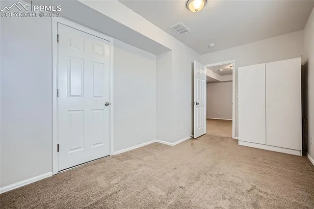 a view of an empty room and closet area