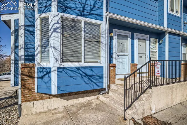 a view of a brick house with a large window