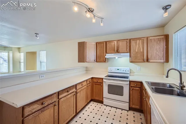 a kitchen with stainless steel appliances a stove sink and cabinets
