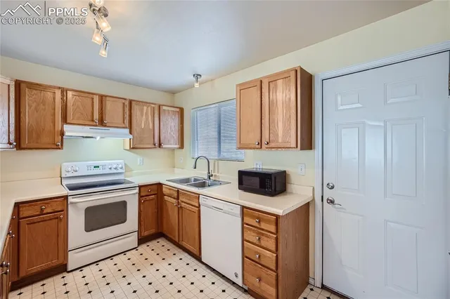 a kitchen with a stove sink and cabinets