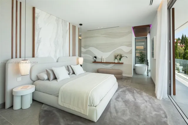 a bedroom with furniture and a large window