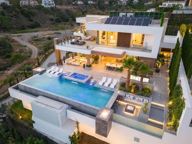 an aerial view of a house with a yard basket ball court and outdoor seating