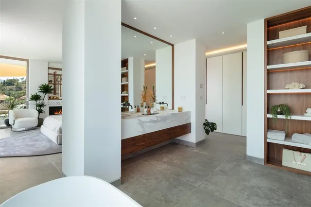 a kitchen with a sink and chairs