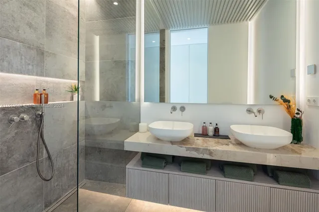 a kitchen with a stove a sink dishwasher and a dining table with garden view