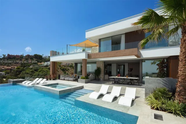 a view of a chairs and table in patio