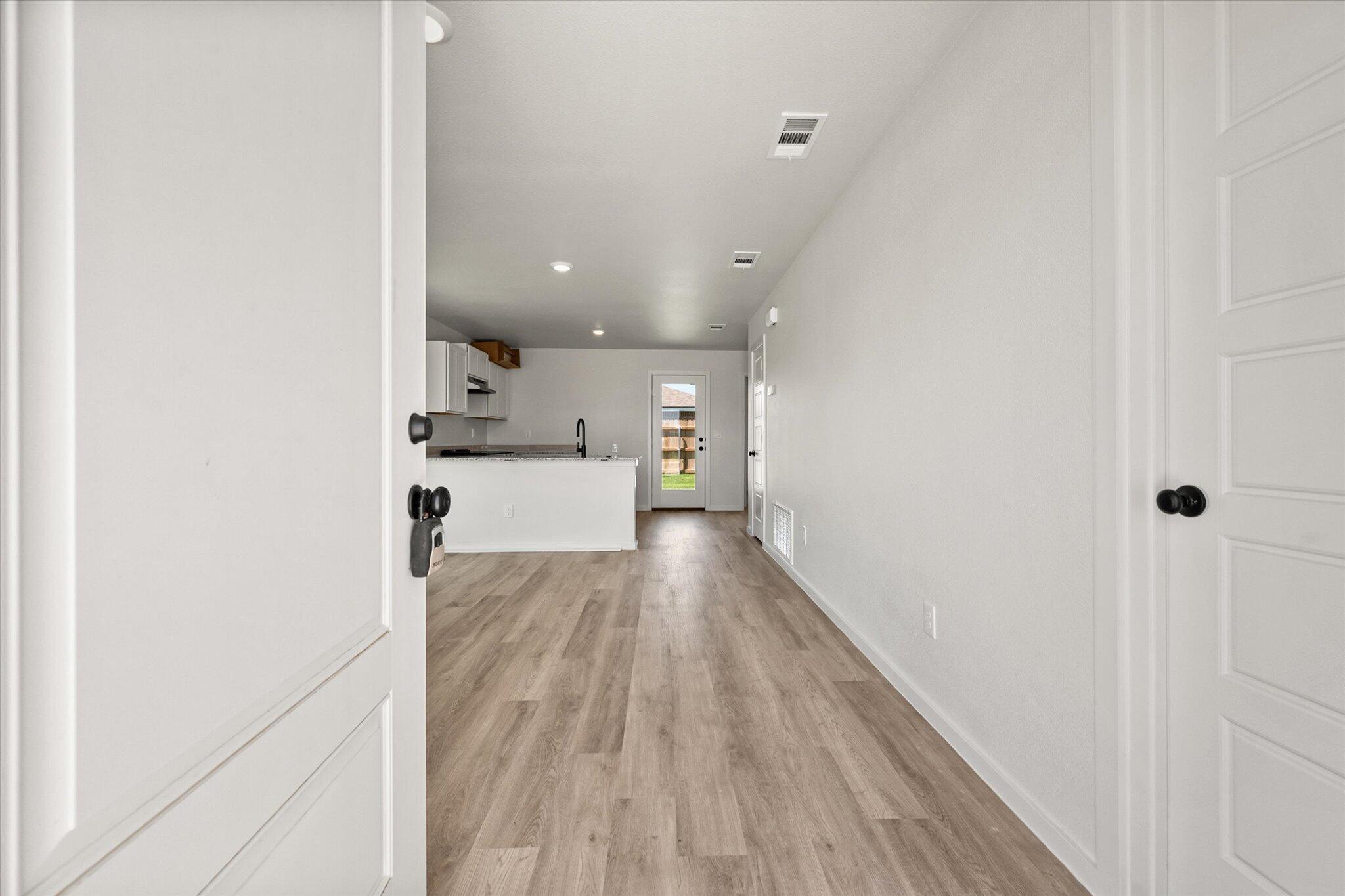 8312 25th Street Lubbock, TX 79407 - Photo 3 of 17 a view of a hallway with wooden floor