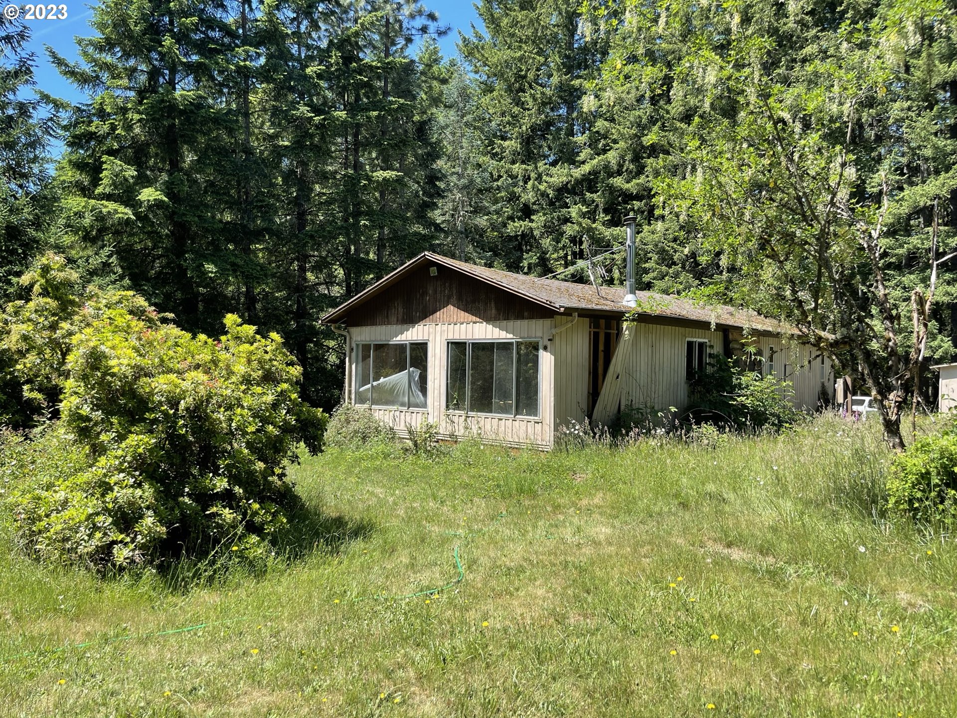 38971 Southeast Rude Road Sandy, OR 97055 - Photo 11 of 46 a house with trees in the background