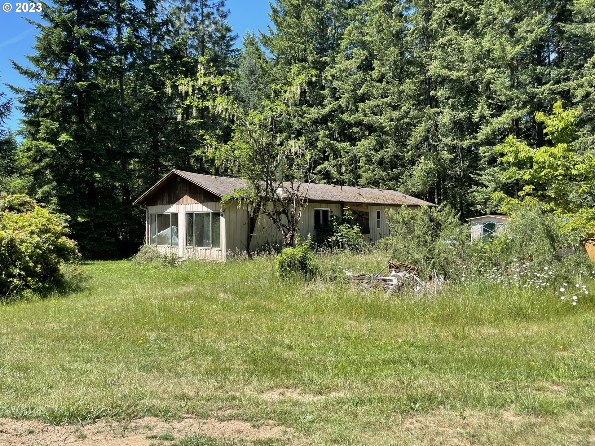 38971 Southeast Rude Road Sandy, OR 97055 - Photo 7 of 46 a front view of a house with a yard