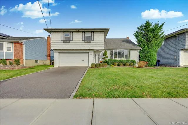 a front view of house with yard and green space