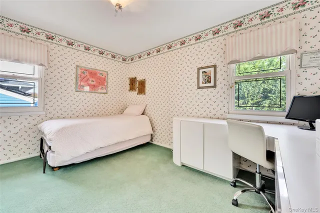 a spacious bedroom with a bed and a cabinet