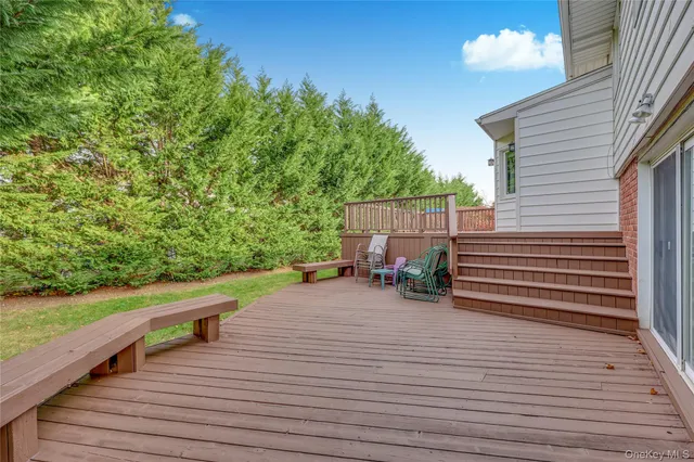 a view of a deck with table and chairs with wooden floor and fence