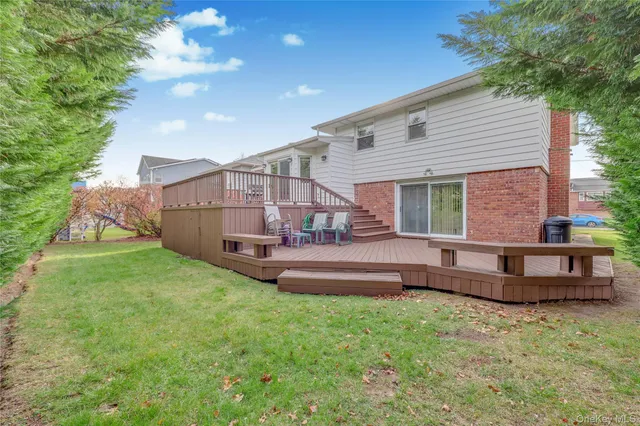 a view of a backyard with plants and wooden fence