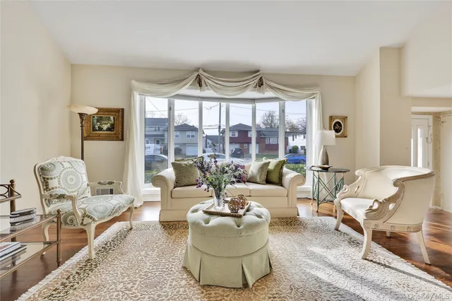 a dining room with furniture a chandelier and wooden floor