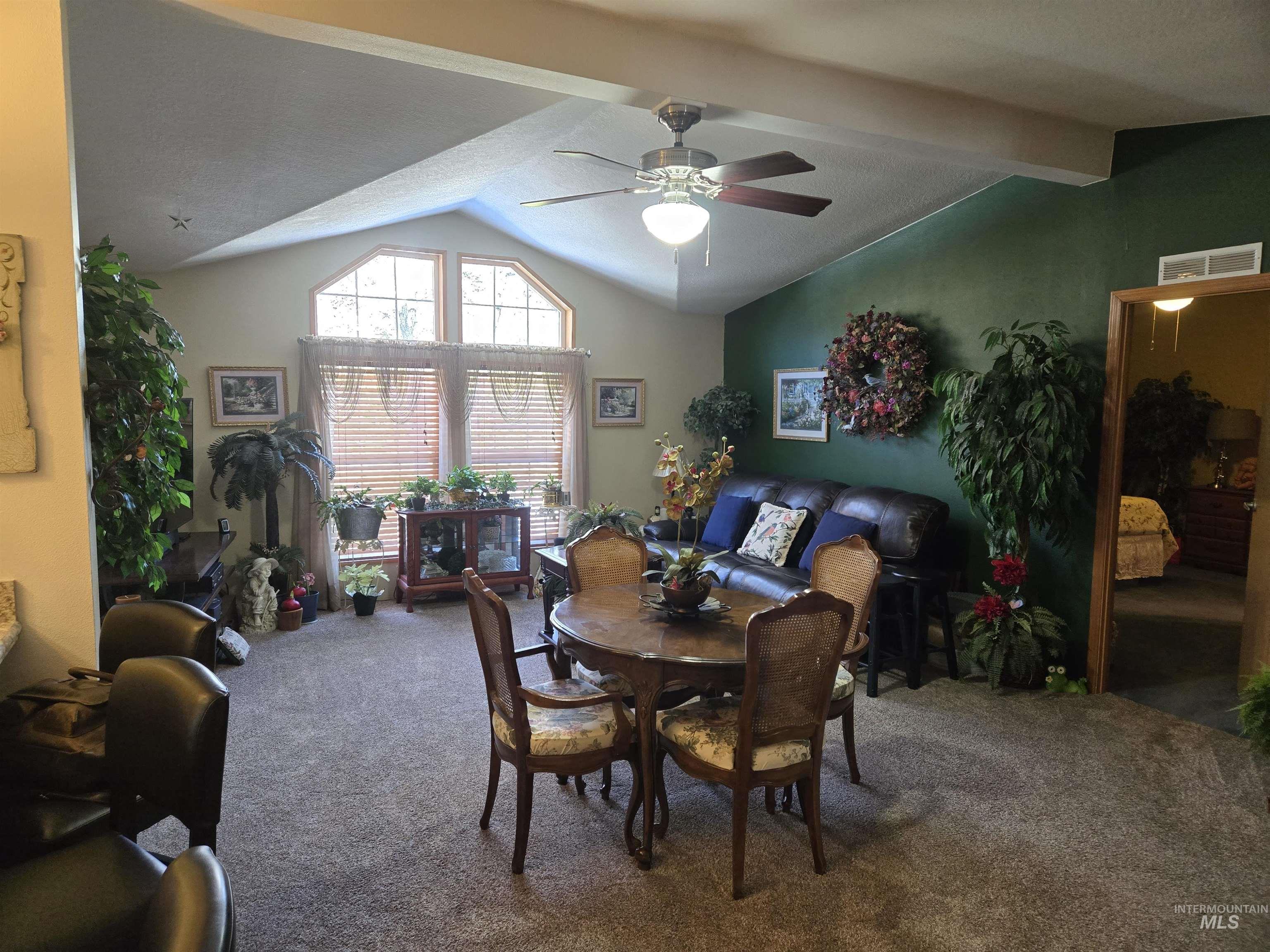 254 Lackey Road Weippe, ID 83553 - Photo 10 of 38 Carpeted dining room with a ceiling fan and beam ceiling