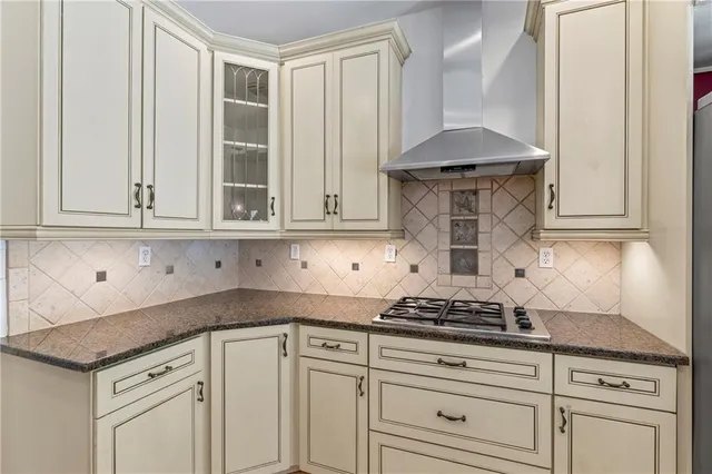 a kitchen with granite countertop white cabinets and white appliances