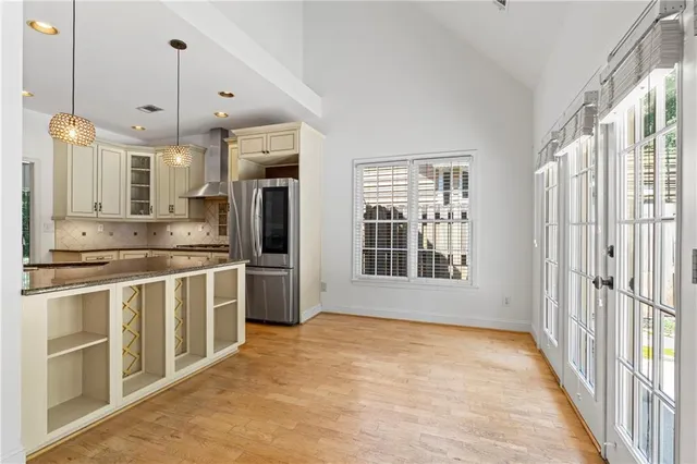 a large kitchen with granite countertop a stove a sink and a refrigerator