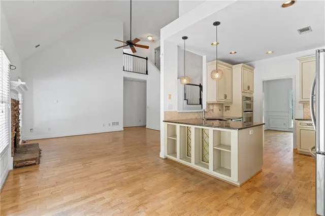 a kitchen with stainless steel appliances granite countertop a sink a stove and a refrigerator