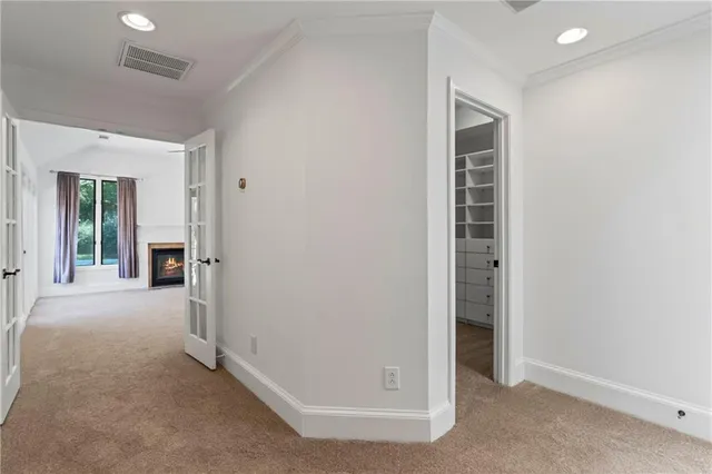 an empty room with windows and closet