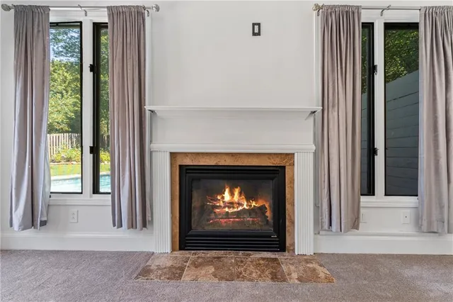 a living room with a fireplace and a window