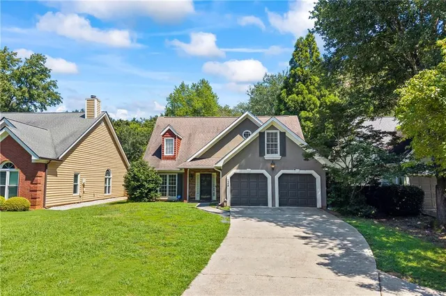 a front view of a house with a garden