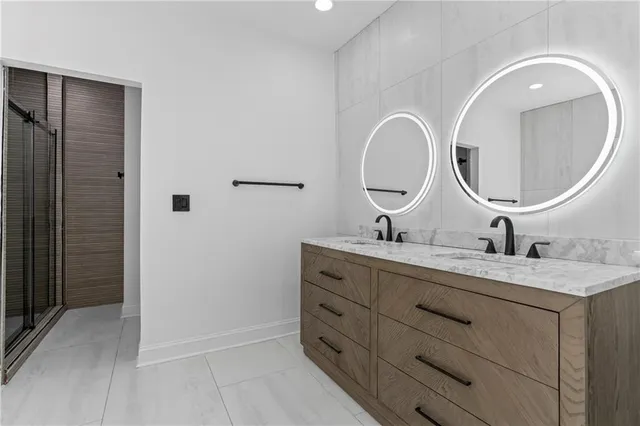 a bathroom with a double vanity sink and a mirror