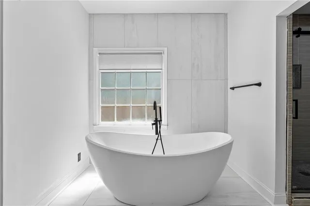a white bath tub sitting in a bathroom