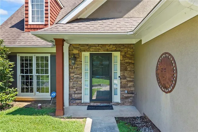 a front view of a house with garden