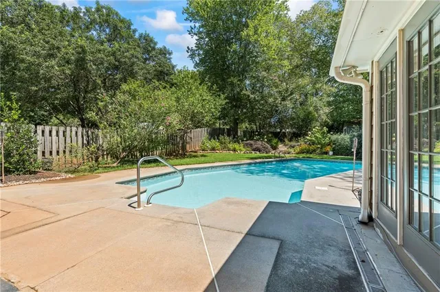 a view of swimming pool with a patio and yard