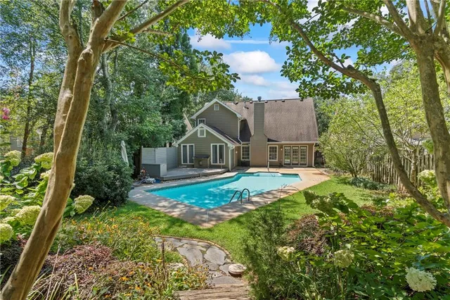 a view of house with outdoor space and sitting area