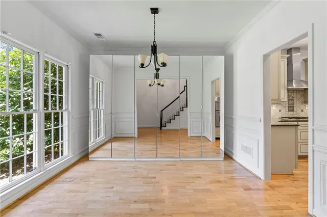 a view of an entryway with wooden floor and a livingroom