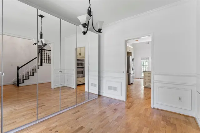 a view of a hallway view with wooden floor and staircase