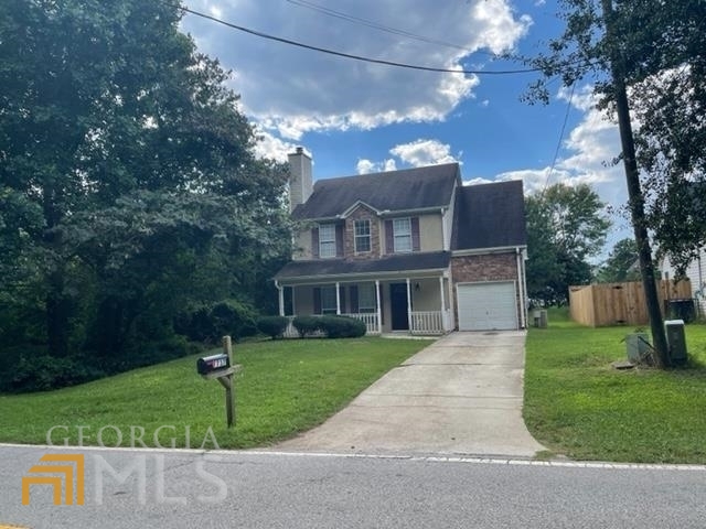 7737 Tara Road Jonesboro, GA 30236 - Photo 1 of 1 a front view of a house with a yard and trees
