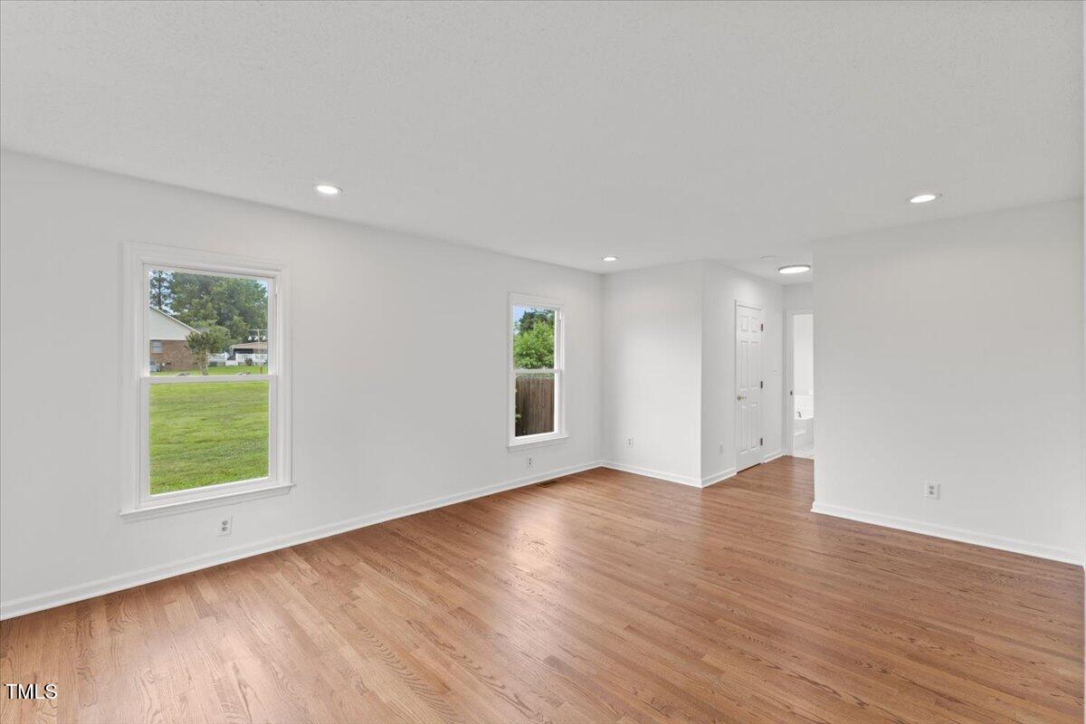 314 Lane Road Dunn, NC 28334 - Photo 16 of 68 an empty room with wooden floor and windows