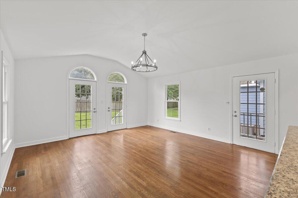 314 Lane Road Dunn, NC 28334 - Photo 30 of 68 an empty room with wooden floor cabinet and windows
