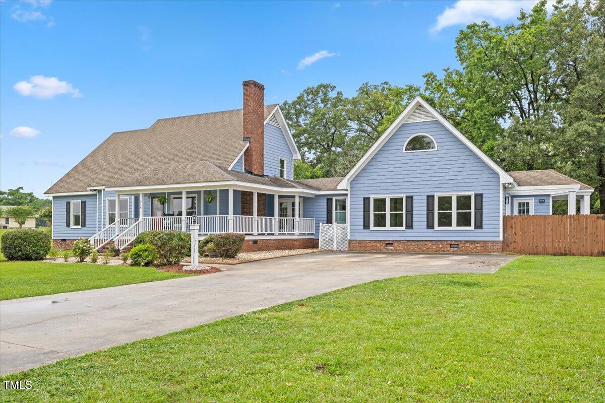 314 Lane Road Dunn, NC 28334 - Photo 3 of 68 a front view of a house with a yard porch and outdoor seating