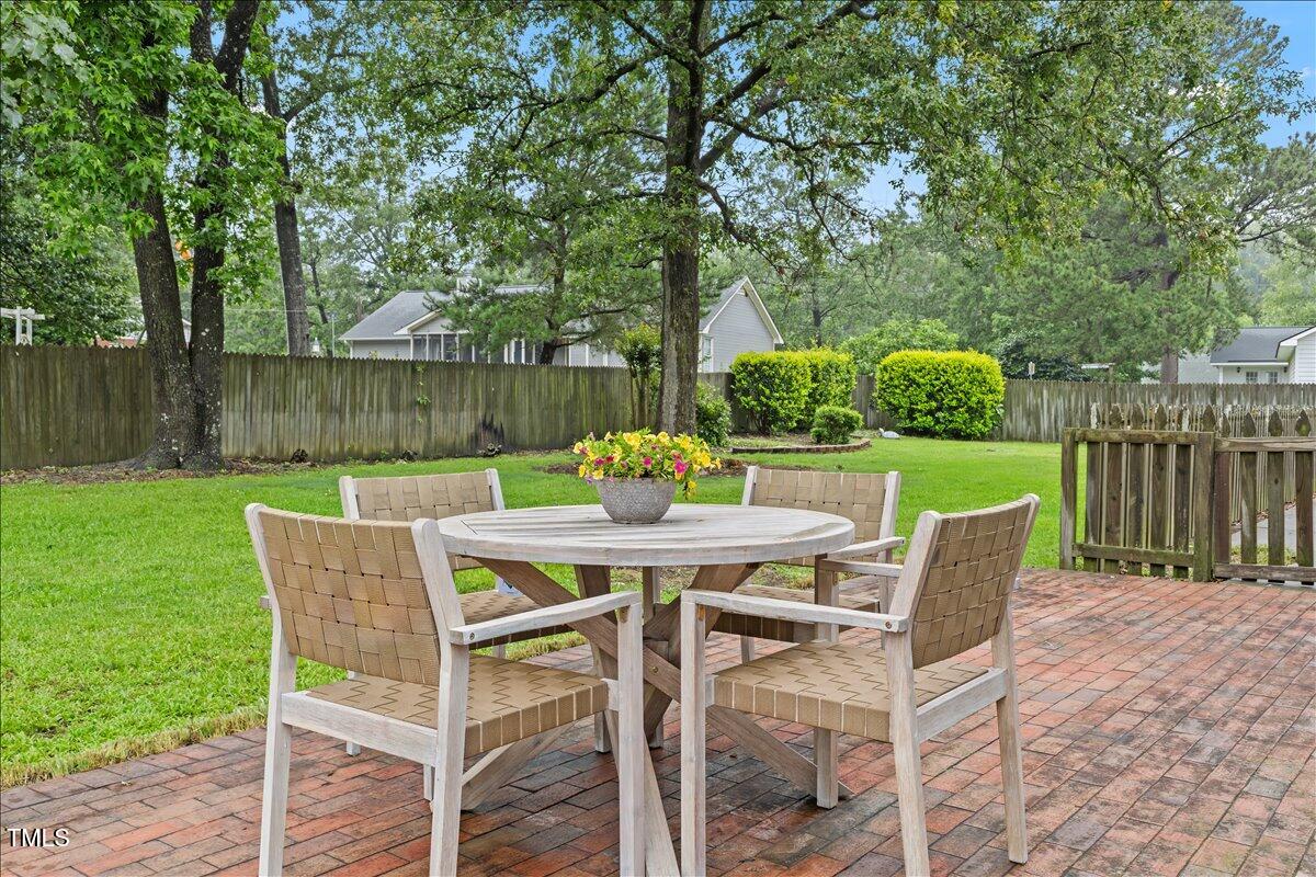 314 Lane Road Dunn, NC 28334 - Photo 52 of 68 a view of a chairs and table in patio with wooden fence