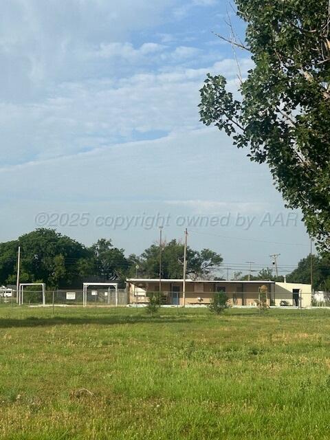 a view of a garden with a building in the background