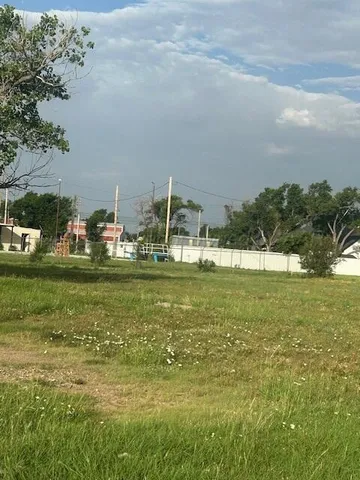 a view of ocean with boats and trees in the background