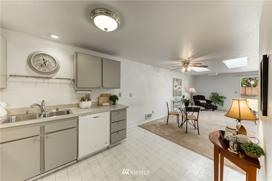 6324 Cady Road, Unit B Everett, WA 98203 - Photo 11 of 22 a kitchen with cabinets and chairs