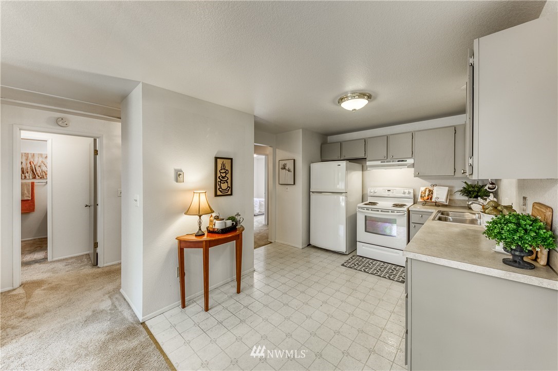 6324 Cady Road, Unit B Everett, WA 98203 - Photo 13 of 22 a kitchen with white cabinets and refrigerator
