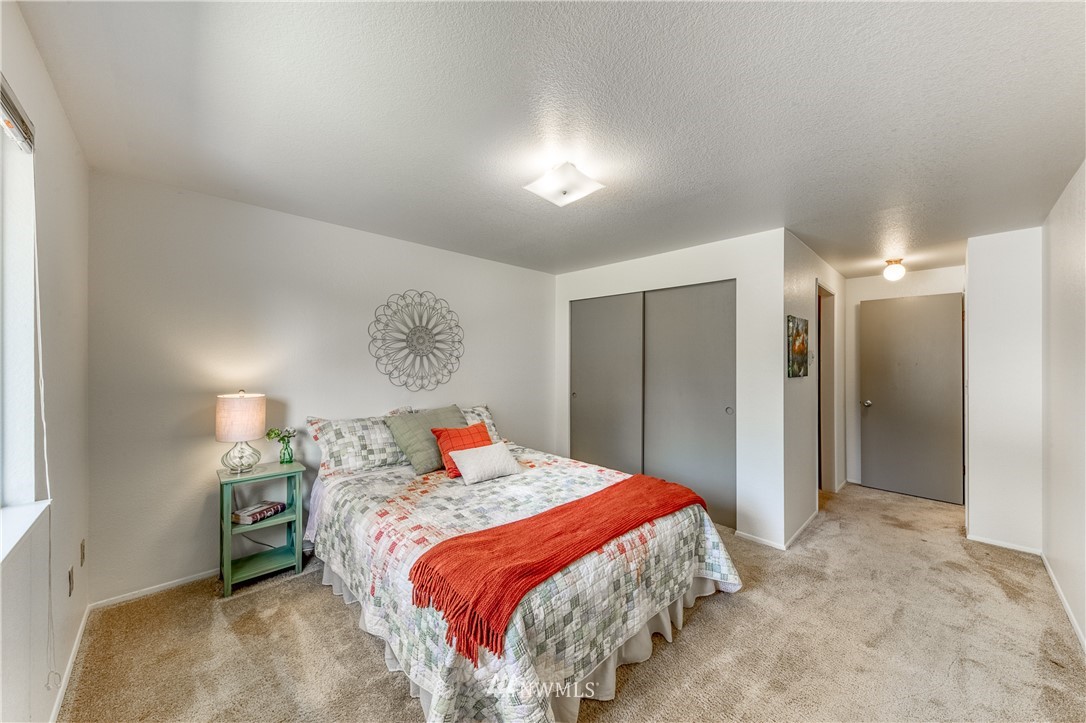 6324 Cady Road, Unit B Everett, WA 98203 - Photo 15 of 22 a bedroom with a bed and a chandelier