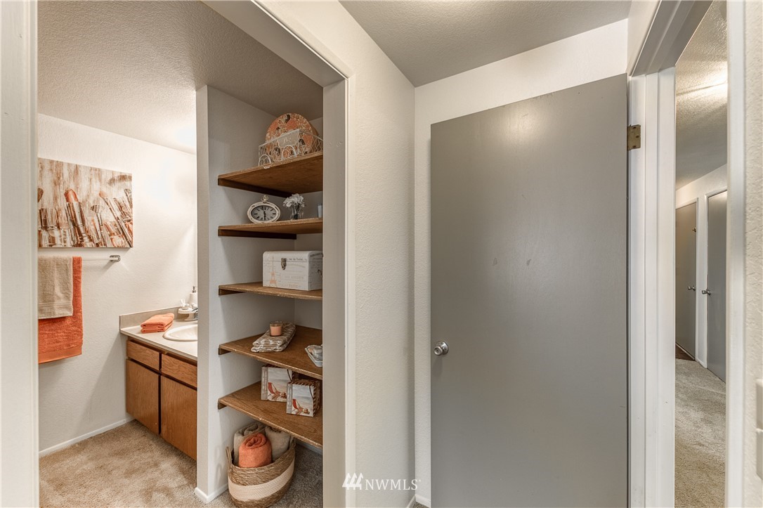 6324 Cady Road, Unit B Everett, WA 98203 - Photo 17 of 22 a view of a hallway to room with wooden floor and cabinets
