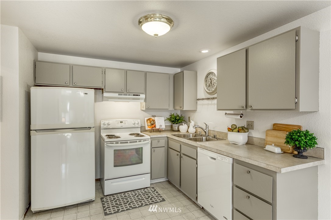 6324 Cady Road, Unit B Everett, WA 98203 - Photo 10 of 22 a kitchen with a white cabinets and white stainless steel appliances