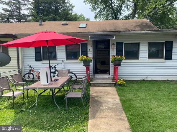 a view of a house with backyard sitting area and garden