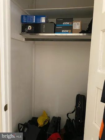 a living room with a bed and a flat screen tv