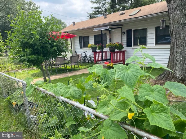 a view of a house with sitting area and garden