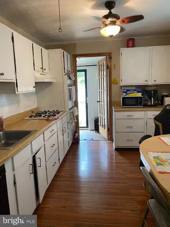 a kitchen with a refrigerator and a stove