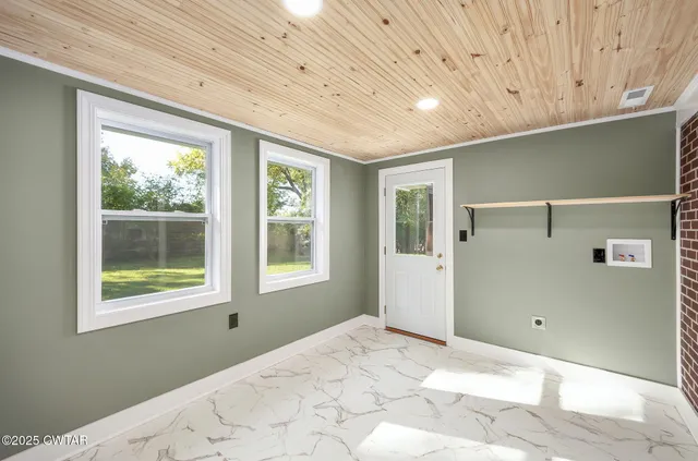 a view of a livingroom with a window and wooden floor