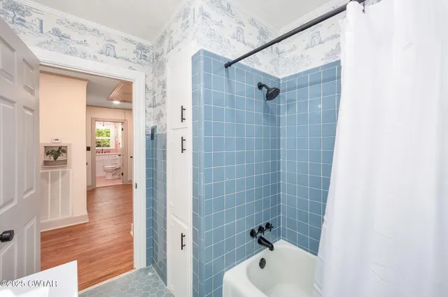 a bathroom with a bathtub and shower